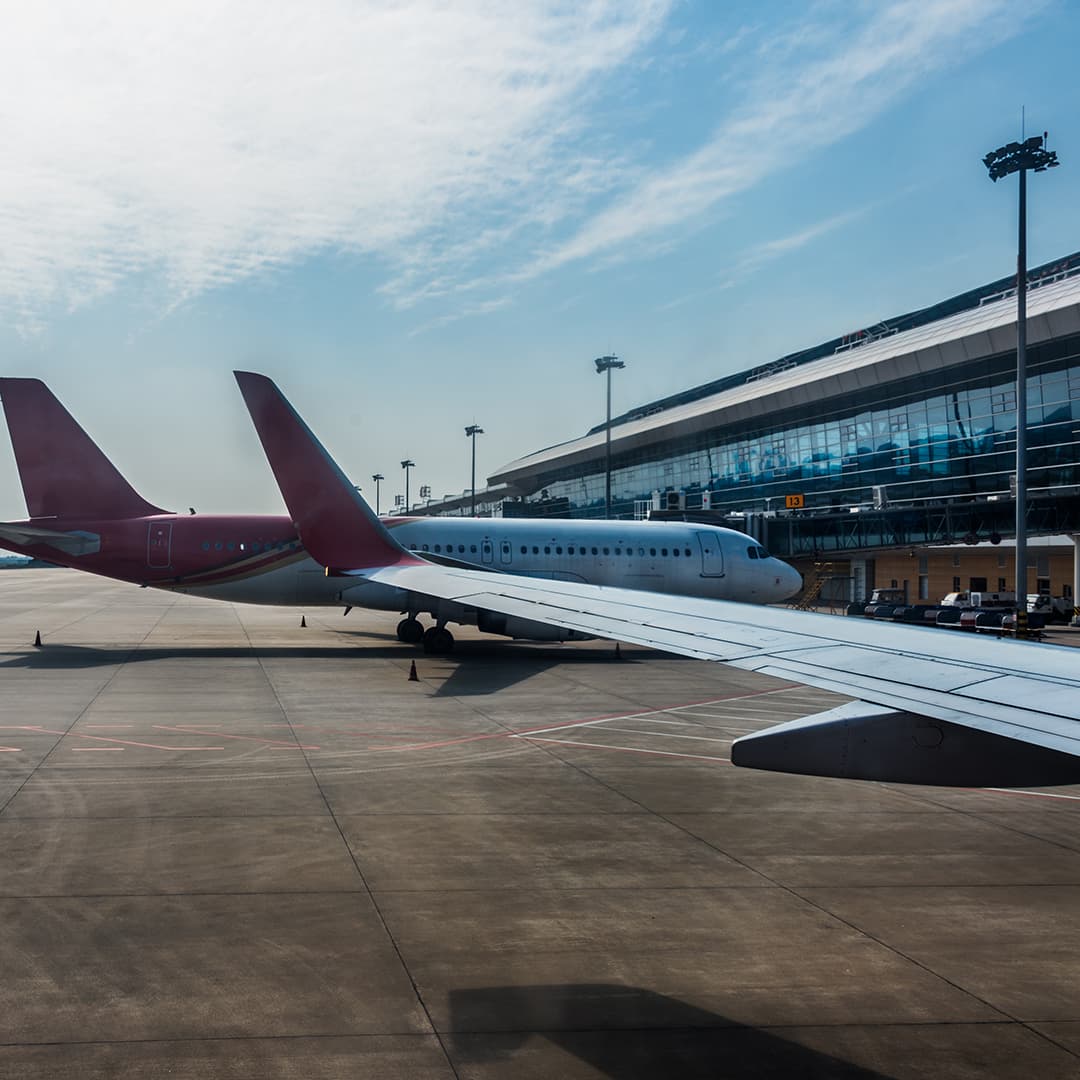 Aircraft parked at an airport terminal where door frame metal detectors screen passengers